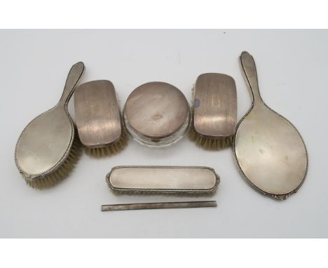 A collection of silver dressing table set items, a three piece set by Adie Brothers Ltd, Birmingham, two clothes brushes by t