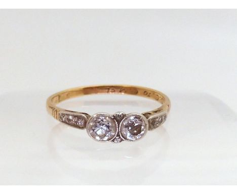 An 18ct vintage twin stone diamond ring, set with estimated approx 0.30cts of old cut diamonds, size S, weight 2.2gms Conditi