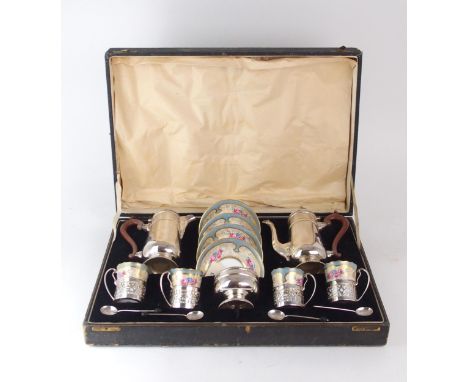 A CASED GEORGE V SILVER MOUNTED PARAGON COFFEE SERVICE the coffee cans and saucers floral and gilt decorated, the silver by C