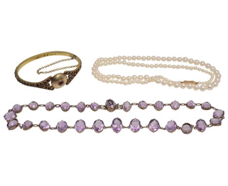 A slightly graduated oval amethyst riviere necklacea graduated cultured pearl necklace to the rectangular box clasp stamped '