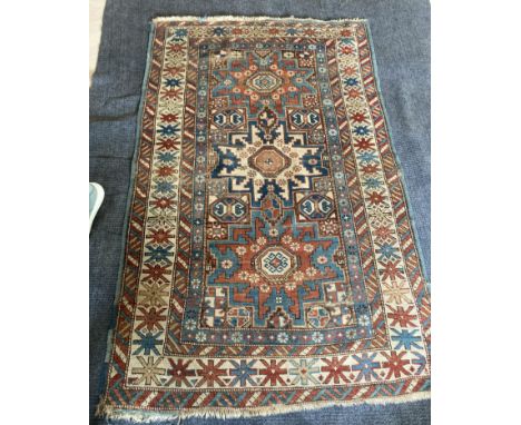A Shirvan rug and another Shirvan exampleearly 20th centurythe main border with geometric star motifs and enclosing three med