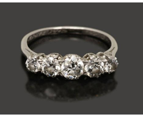 A graduated five stone diamond ring the old brilliant-cut diamonds coronet-set to the plain tapering shank, the interior with