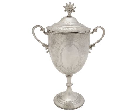 A late Victorian silver twin handled trophy cup and coverLondon, 1878 by William Hutton &amp; Sons the bowl with vacant ovals