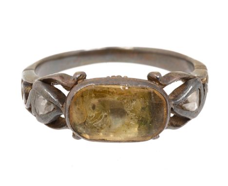 An early 18th century yellow stone and diamond-set ring, the central oval foiled yellow stone (possibly a topaz), applied sca