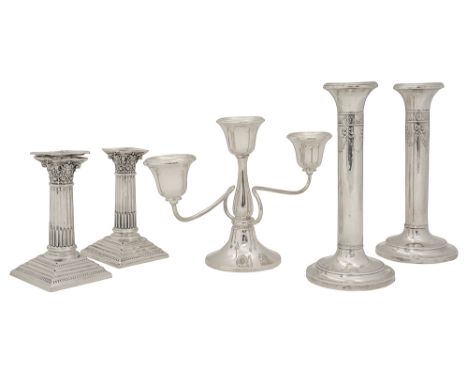 Two pairs of Edwardian candlesticks and a George V three light candelabrumfirst Birmingham, 1904 by Henry Matthews, plain col