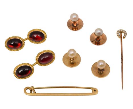 A small collection of gentleman's accessories  a pair of oval garnet cufflinks with ropetwist border, the closed back setting