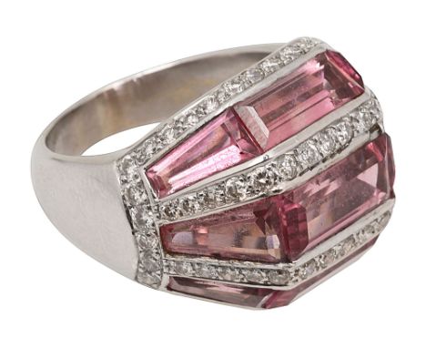 A stylish pink topaz and diamond-set ringof faceted arched design, set with three rows of tapering baguette-cut pink topaz, s