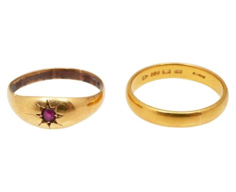 A 18ct garnet ring and a 22ct gold wedding bandpink stone set ring stamped '18ct' and the wedding band also stamped, (2) Wedd