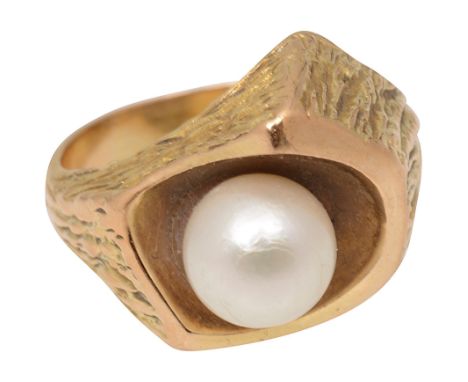  A mid 20th century cultured pearl abstract ring the cultured pearl set within a smooth recess to the textured sides and shou