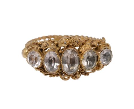 An early 19th century yellow gold and white stone ring, the five graduated oval stones collet-set  within the cannetille, bea