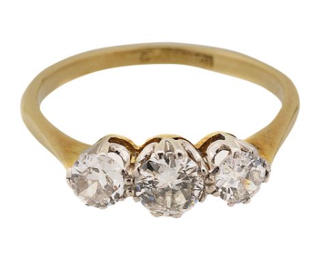 A diamond three stone ring set with very slightly graduated modified brilliant-cut diamonds to the coronet setting and plain 