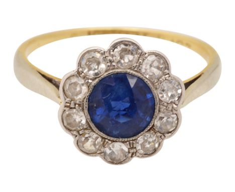 A sapphire and diamond-set cluster ring the central circular-cut sapphire within a surround of single-cut diamonds to the tap