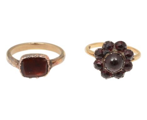 Two 19th century garnet closed-back ringsthe first rectangular flat-cut garnet within a cut-down collet transversely-set to t