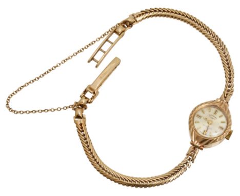 A lady's yellow gold wrist watch by Rotary the ornately-engraved bezel to the circular dial with baton markers and signed  'R