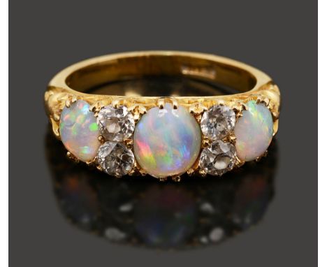 A late Victorian opal and diamond-set ring the three graduated oval opal cabochons separated by two pairs of old-cut diamonds