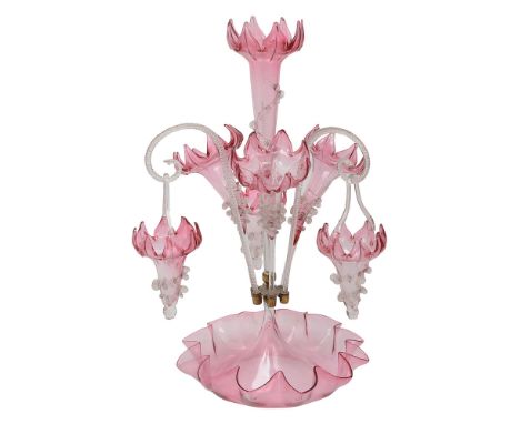 A Victorian cranberry fading to clear glass epergne centrepiecehaving central larger petal edge trumpet shaped vase with crim