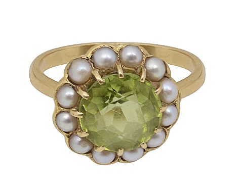 A peridot and seed pearl circular cluster ring to the plain tapering shank stamped '18CT'ring size N, 4.6gCondition: 