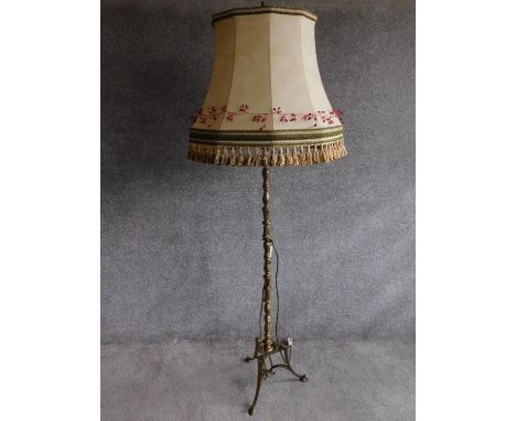 A vintage tripod base brass standard lamp with sectioned detailing. H.176cm 