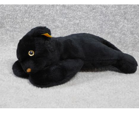 A Steiff vintage toy of a young black panther. With label and gold button. Plastic eyes. W.31cm 