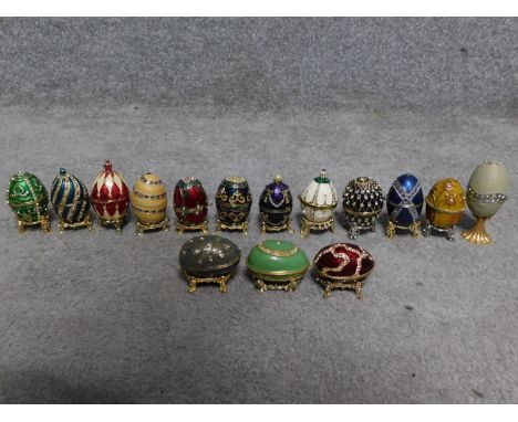 A collection of fifteen Faberge style enamel and diamante egg trinket boxes. All have magnetic fastening. Some have metal sta