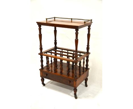 A Victorian rosewood Canterbury whatnot, brass gallery on turned supports, single frieze drawer on turned legs on brown ceram