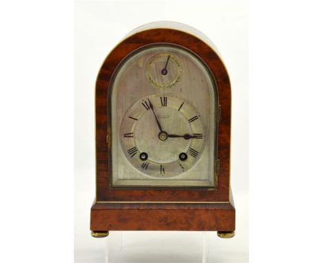 An early 20th century library clock retailed by Martin & Co., Cheltenham. The silvered dial with applied Roman numerals chapt