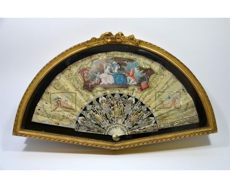 λ A mid-18th century French fan. The silk leaf painted in body colour with a finely dressed gentleman offering a bird to an e