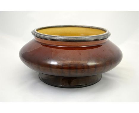 A Linthorpe pottery Henry Tooth bowl designed by Christopher Dresser with a treacle glaze. Impressed marks. Height 12cm.