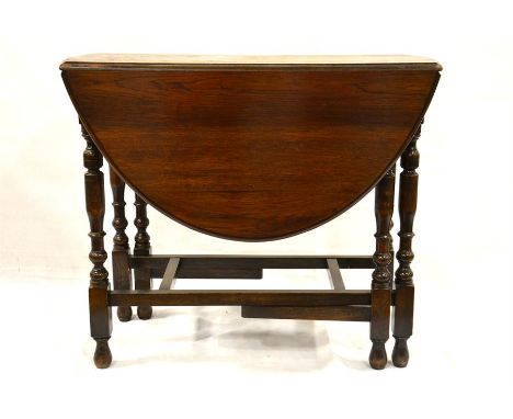 An early 20th century gate leg table with turned legs. Height 76cm, length 92cm, width 120cm, 45cm closed. Also a set of four