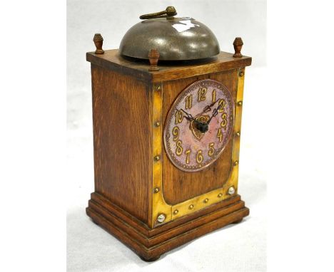 A Continental secessionist mantel clock, the rectangular oak frame set with brass plates and circular copper dial, Arabic num