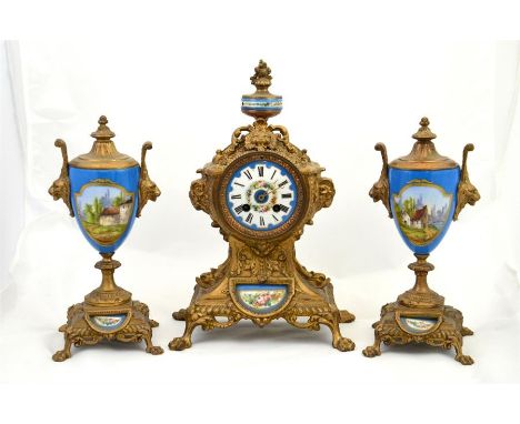 A clock garniture with Sevres style porcelain plaques and roundel and the dial decorated with a floral pattern and Roman nume