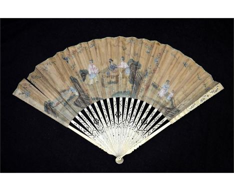 λ An 18th century Chinoiserie fan with carved and pierced ivory guards and sticks, the upper guards with scrolls and flowers.