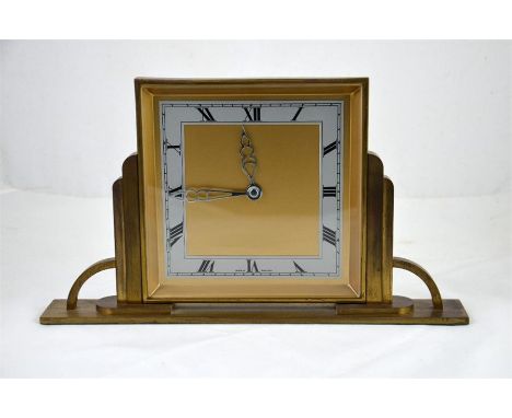 An English art deco clock made of brass with Roman numerals. Height 18cm.
