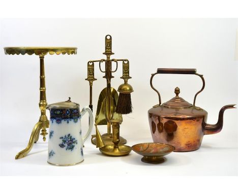 A group lot of brass and copper ware including a fire side set, a chamber stick and a table. Also a Britannia jug with metal 