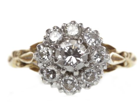 EIGHTEEN CARAT GOLD DIAMOND CLUSTER RINGset with a central round brilliant cut diamond of approximately 0.32 carats surrounde