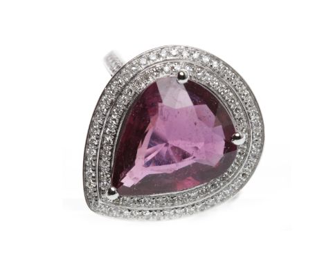 FOURTEEN CARAT GOLD RUBY AND DIAMOND RINGset with a central pear cut ruby of approximately 4.19 carats within a double halo o
