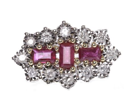 NINE CARAT GOLD RUBY AND DIAMOND RINGwith a boat shaped bezel 21mm long and set with three step cut rubies, surrounded by ill