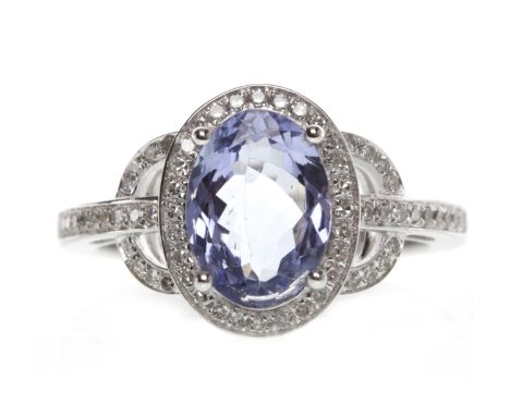 FOURTEEN CARAT GOLD TANZANITE AND DIAMOND RINGset with a central oval tanzanite of approximately 1.87 carats, within a diamon
