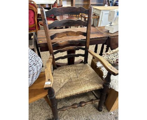 A ladder back and rush seated carver chair