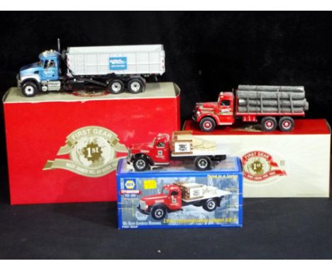 Diecast - First Gear - Three First Gear boxed 1:34 scale diecast model Mack trucks comprising Mack L Series Logging Stake Tru