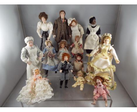 Dolls House Accessories - a collection of fourteen ceramic faced dressed dolls to include adults and children ranging in size