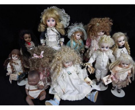 Dolls - a collection of six Little Heirloom ceramic faced dolls ranging in size from 24 cm to 13 cm some with stands and five