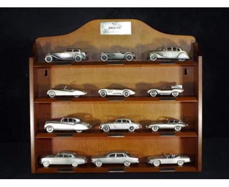 Diecast - Danbury Mint - twelve unboxed pewter model cars from Jaguar The Classic Motorcars  Collection on wooden shelf stand
