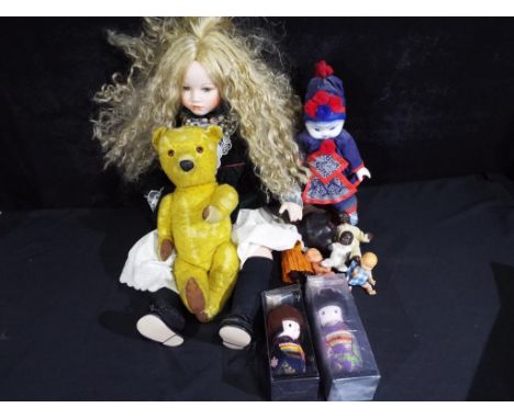 A good mixed lot of dolls to include a ceramic faced doll by Alberon, two boxed Japanese Kokeshi dolls, a porcelain faced Asi