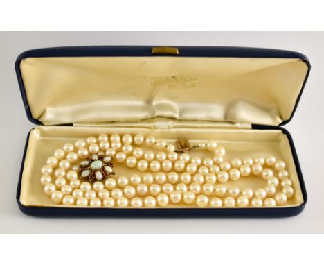 A Double Strand Necklace of Cultured Pearls, 20th Century, two strands of cultured pearls with 9ct gold opal and ruby clasp, 