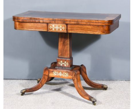 A George IV Rosewood and Brass Inlaid Rectangular Card Table, the baize lined folding top inlaid with wide band of leaf scrol