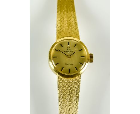 An 18ct Gold Lady's Manual Wind Wristwatch,  by Omega, 18mm diameter case, champagne dial with black baton numerals, integral