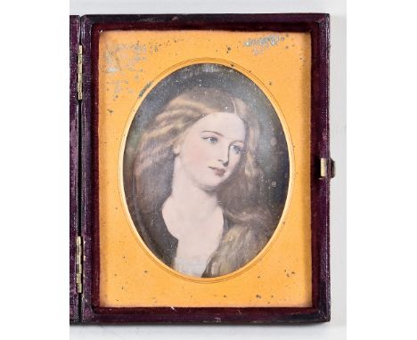 A Tinted Miniature Shoulder Length Portrait Photograph, Mid-19th Century, of a young woman, oval 3.25ins x 2.5ins, in red lea