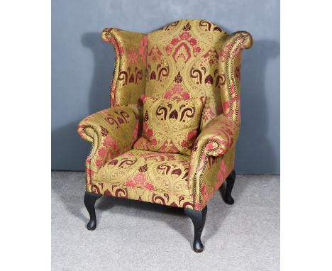 A 20th Century Wingback Easy Chair of Georgian Design, with arch cresting, upholstered in tapestry cloth, on cabriole front l