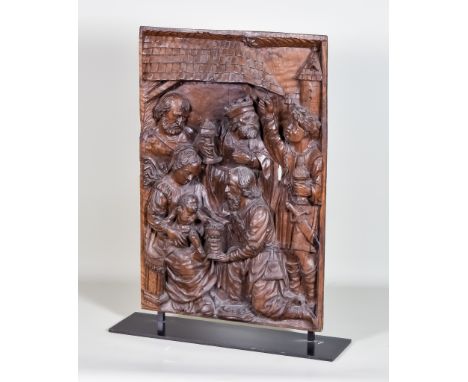 A Low Countries Carved Walnut Panel of the Adoration of the Magi, c.1500, the three kings shown in traditional pose offering 